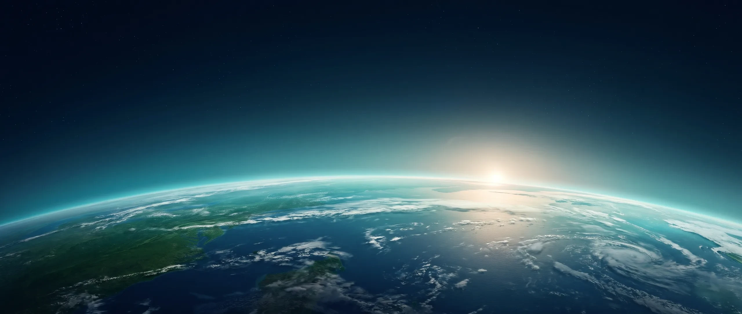 The world in the light of the rising sun beneath a calm horizon.